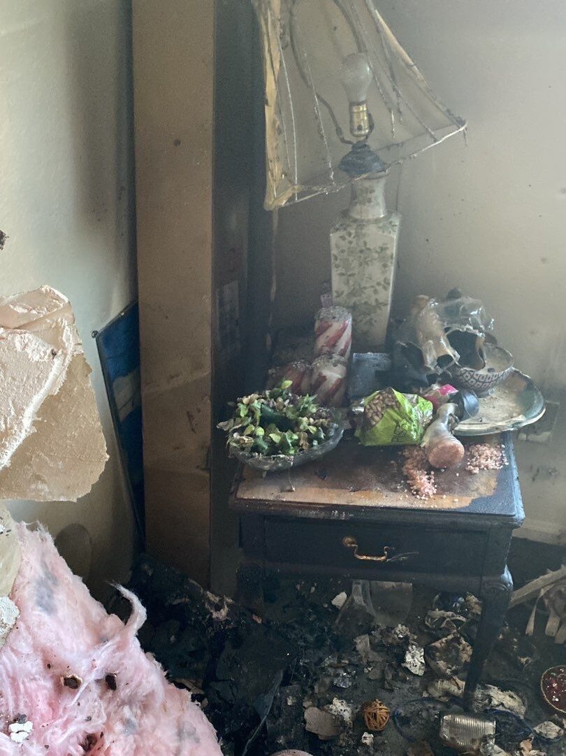 fire damaged bedroom contents covered in soot and debris